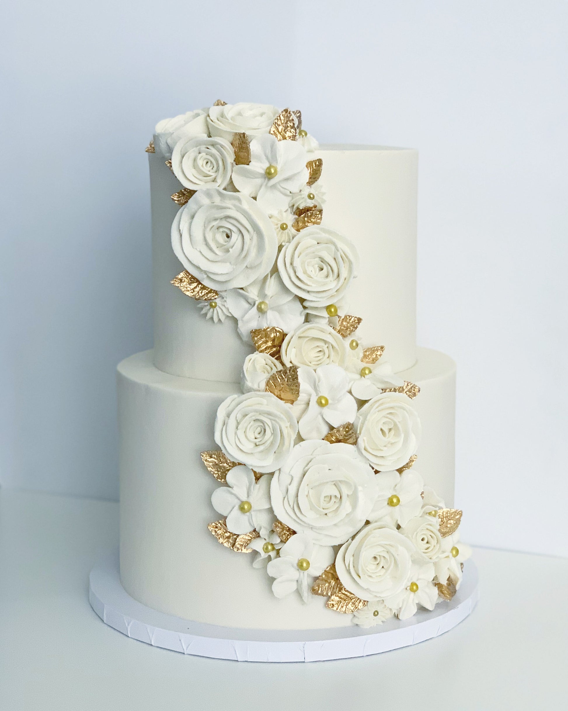 One Tier Buttercream Cake Gilded in Gold Leaf and Topped with Buttercream  Swirls and Sprinkles
